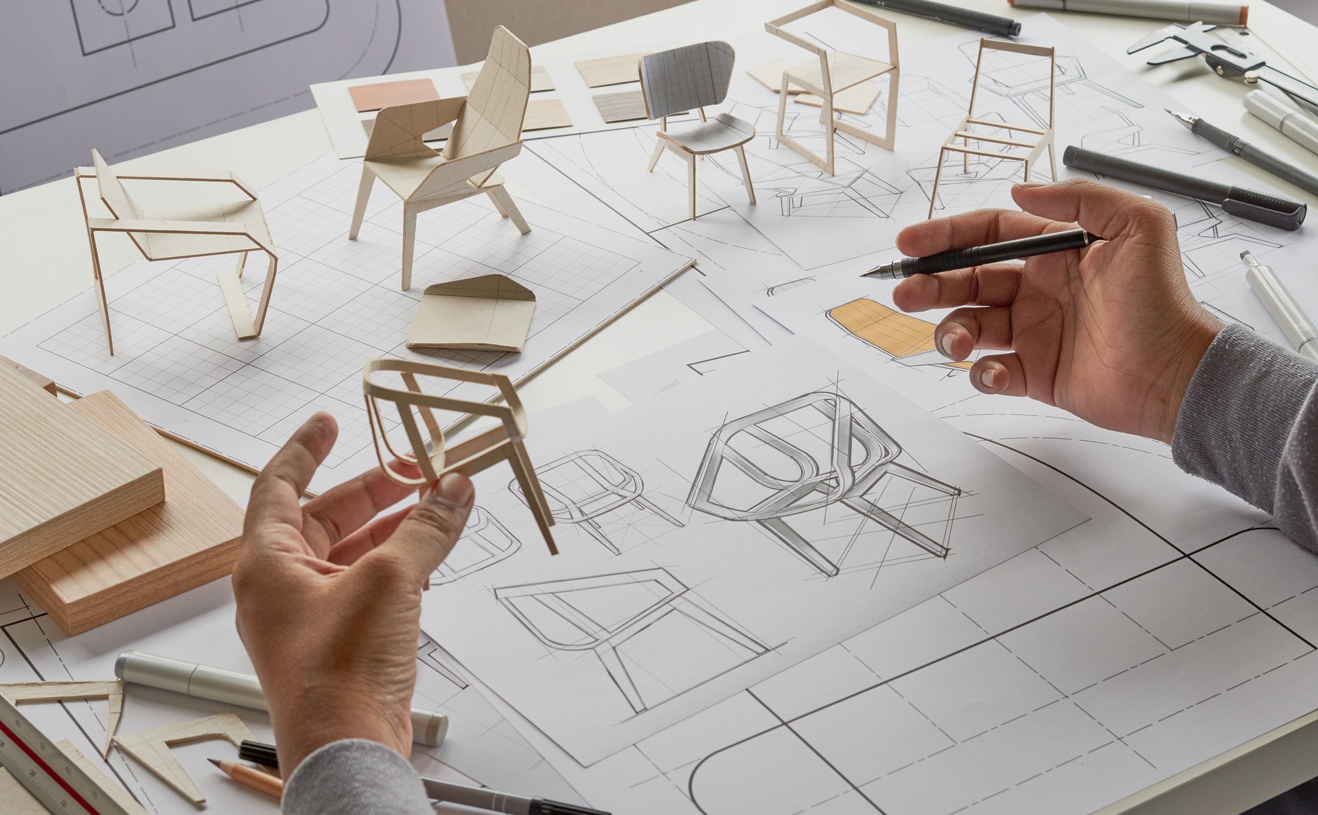 Designer sketching drawing design development product plan draft chair armchair Wingback Interior furniture prototype manufacturing production. designer studio concept .